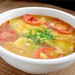 Fried egg and tomato soup